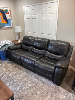 Reclining black leather sofa