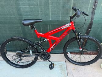 red Dynacraft Gauntlet 24" Mountain Bike showcasing its dual-suspension steel frame and 18-speed configuration
