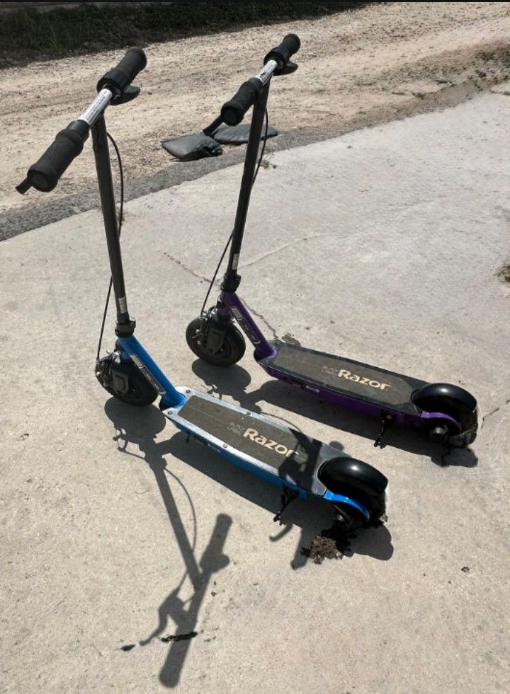2 Razor E100 Black Label Electric Scooters. One Works Perfectly. One Needs A Charger
