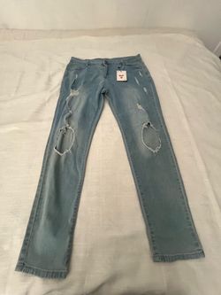 light wash distressed denim jeans from the brand Reverb,