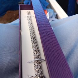 Diamonds in silver bracelet.