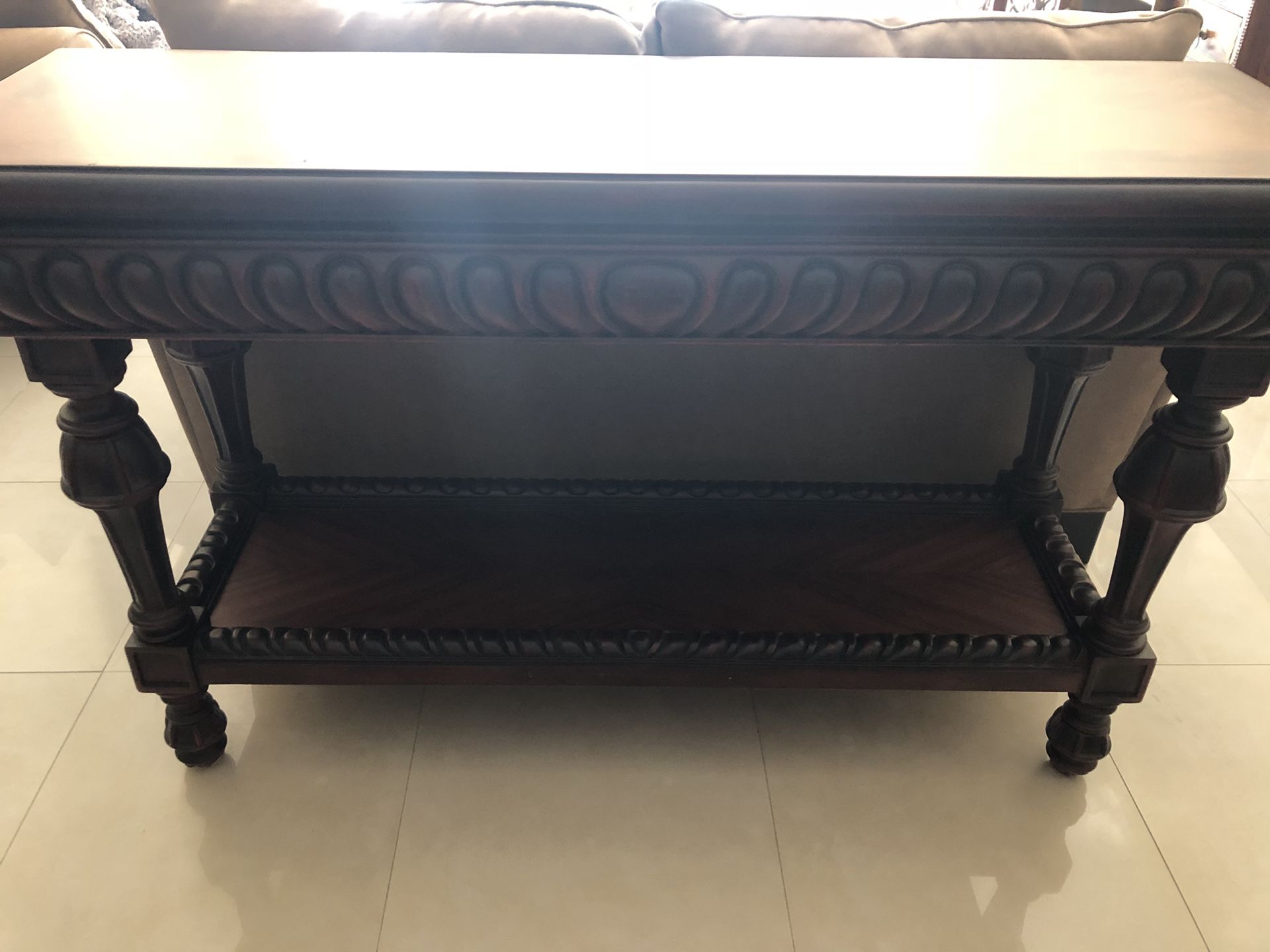 59 1/2” long solid wood table w/ carved features.
