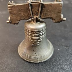The Liberty Bell Pennsylvania Souvenir Figurine is a miniature replica of the iconic symbol of Pennsylvania - the Liberty Bell. This collectible item 