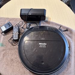 Miele Scout RX2 HOME VISION Model SLQL0 with remote and charger base. Tested. Working good.  Description Robot vacuum cleaner with live image feed and