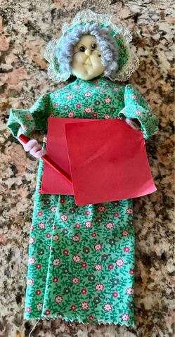 Vintage Handmade Wall hanging Fabric Grannycore carrying a red memo pad on her waist holding red pencil and paper