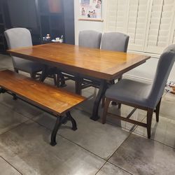 Wood dining table including 4 chairs and the bench