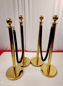 Four Gold medal Stanchions with two black ropes