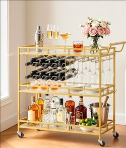 Two-tier gold bar cart! Includes a holder for wine bottles and glasses!