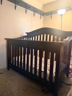 Dark brown wood baby crib