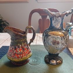TWO REALLY NEAT LOOKING POTTERY VASES 7,5 INCHES TALL AND 10INCHS TALL 