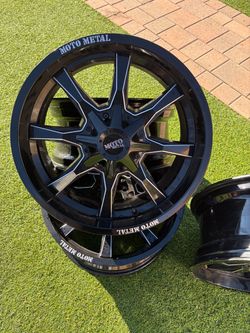 Set of four 20x9 Moto Metal rims with a universal 5-lug pattern. Black with machined accents.