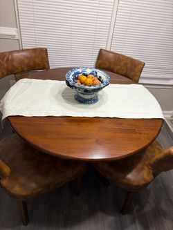Round table with 4 brown leather chairs