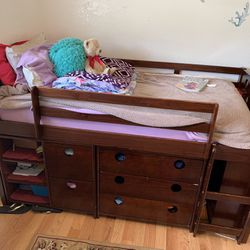 Matching Bed Set With Dresses In Bookshelves Under Them