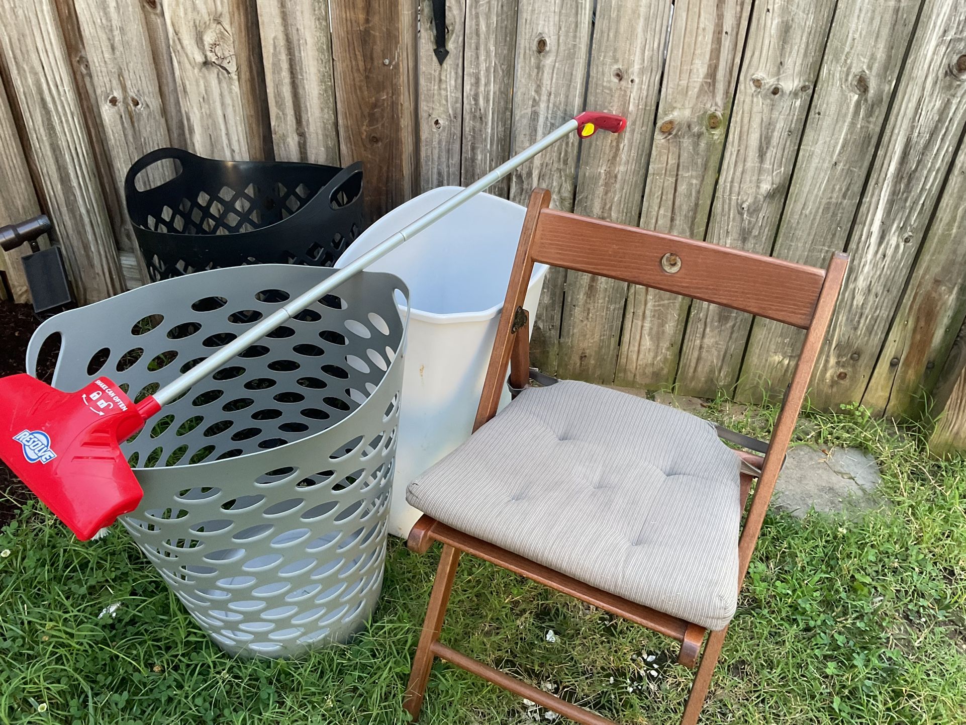Two Beautiful Laundry Baskets, A Black And A Grey One Which Has A Little Cut.  Two Kitchen Trash  Cans, A Wooden Folding Chairs To Fold The Clothes.