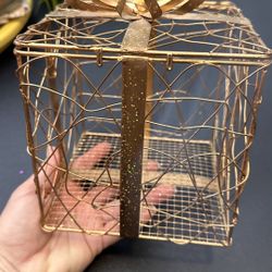 Elegant gold wire gift box with a bow. Perfect for decoration. 