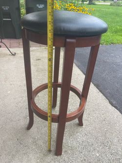 Two swivel bar stools, black top and brown base, used but in good condition.