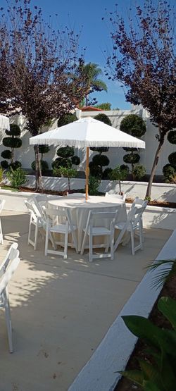 Mesas redondas 54" manteles sombrillas sillas de madera blanca