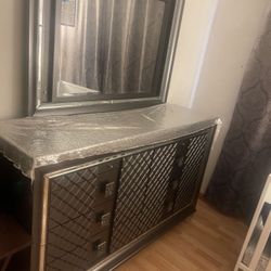 Queen Bed Along With A Mattress And A Dresser 