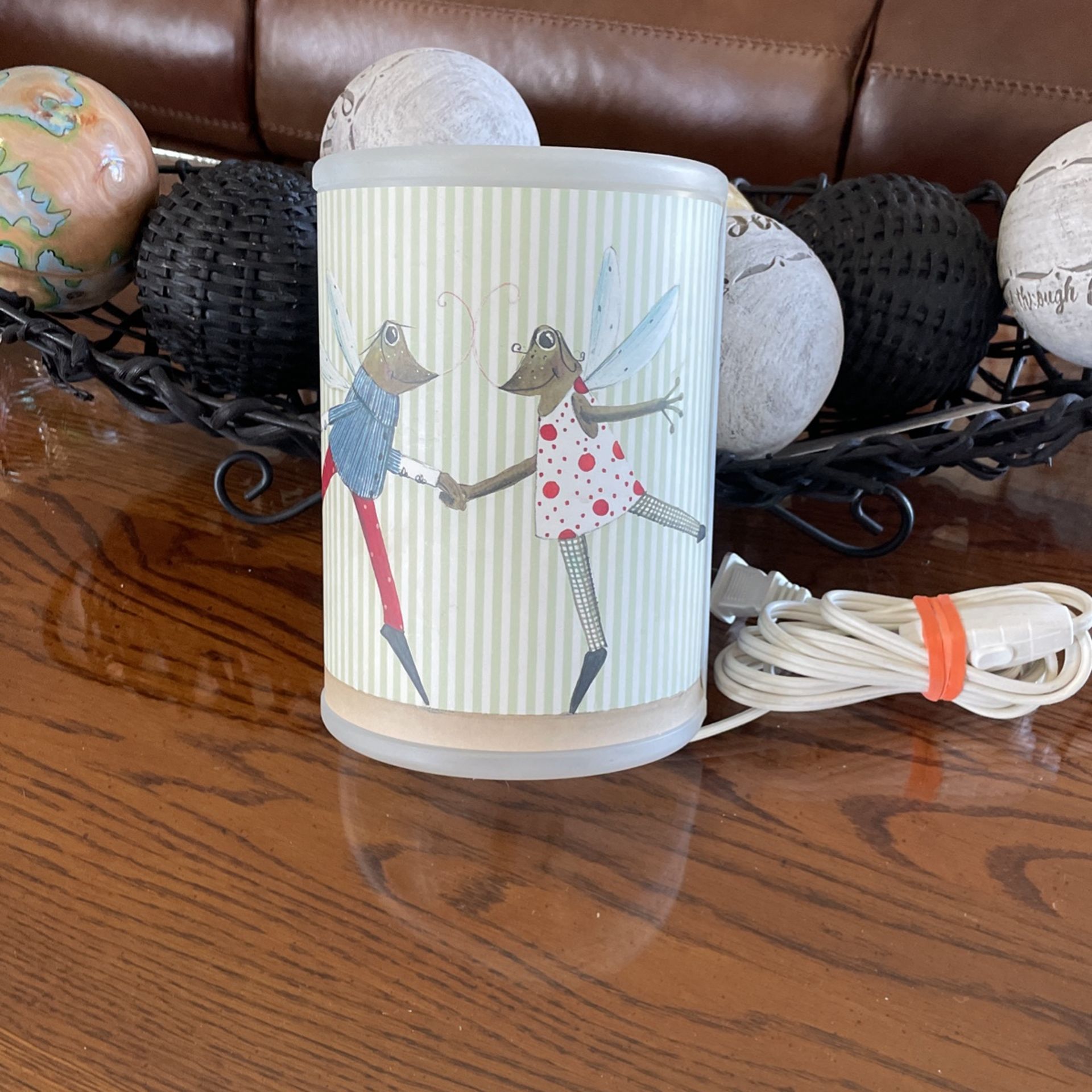 Childs lamp. It hangs on the wall has an often on switch on it.