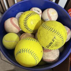 Large bucket of mixed baseballs and softballs