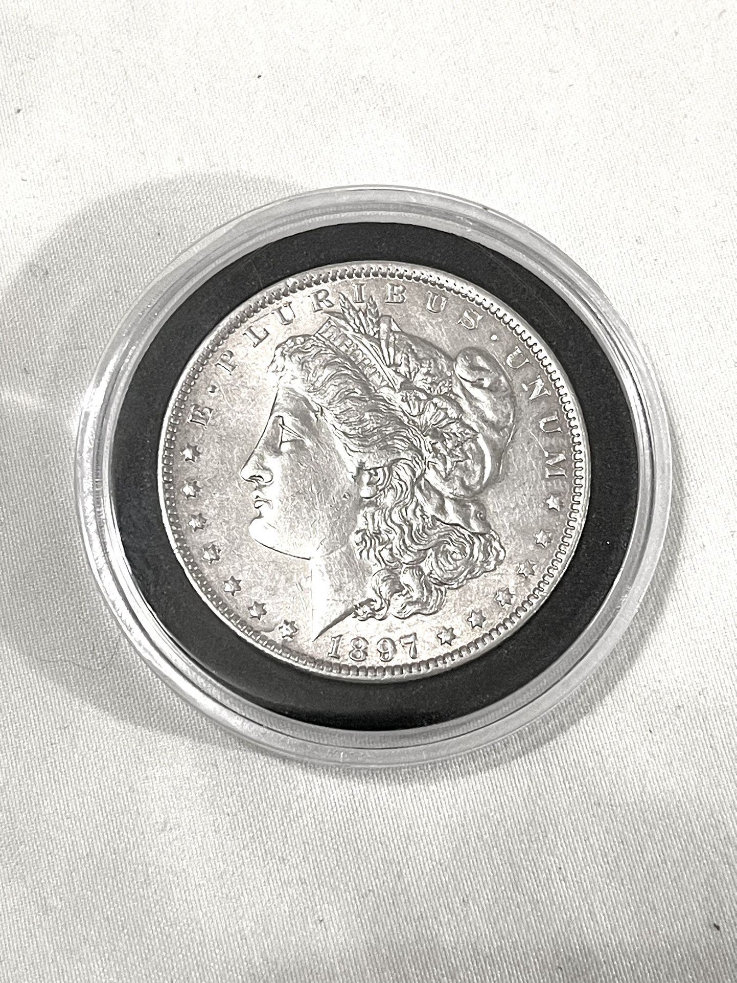 About Uncirculated-AU(50) 1897-P Morgan Silver Dollar. Valued $86 on US Coin book.
