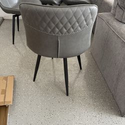 4 gray swivel chairs