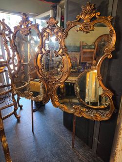 vintage triptych vanity mirror with an ornate Rococo-style gold frame