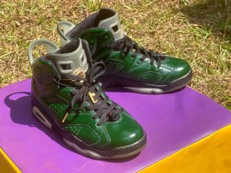 8.5 pair of green and gold Air Jordan 6 Retro "Champagne Bottle" sneakers featuring a glossy upper and speckled midsoles.