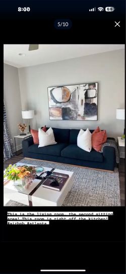 Sofa, picture, and coffee table with lamps and end tables.