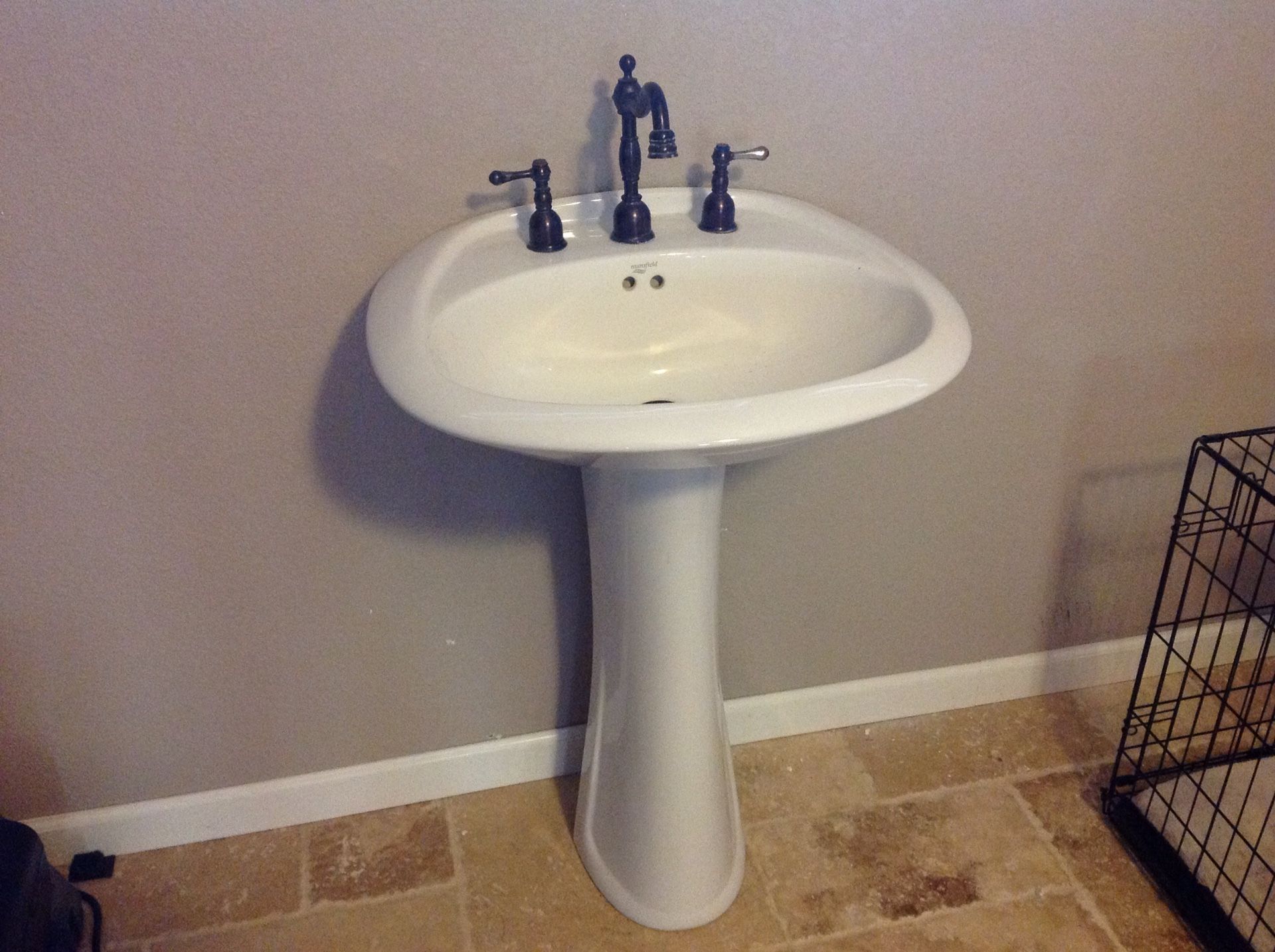 Pedestal sink with oil rubbed bronze faucet