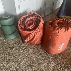 2 LARGE ORANGE SLEEPING BAGS