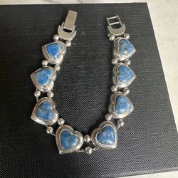 925 Sterling Silver Hearts Bracelet with genuine lapis stones , will fit 7.75- 8 in. Adjustable closure, sterling beads and moon end caps . Beautifull