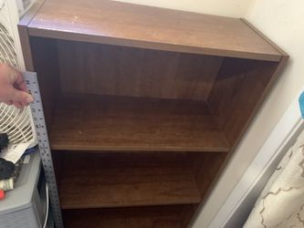 Brown bookshelf, about 40 inches by 22 1/2 x 10 inches deep