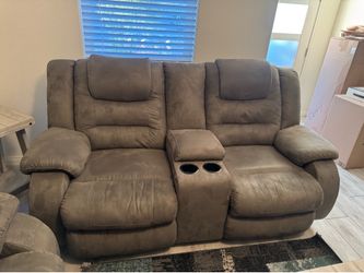 Grey couches / recliners and small tables