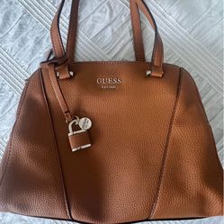 Guess Tan color Shawna cali faux leather satchel purse/ hand carry, multi pockets.