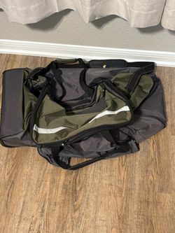 Green duffle bag on wheels