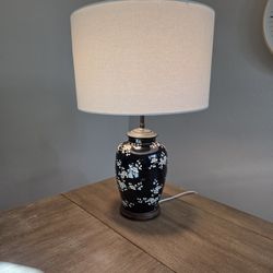 Chinese Porcelain Lamp With White Cherry Blossom Flowers over Black Background