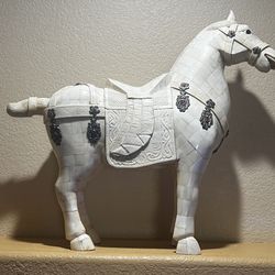 Bone sculpture of horse with decorative saddle and sterling silver medallions