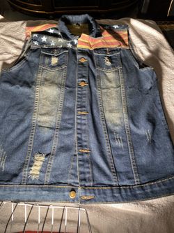 Brand new- never worn, rustic, Jean jacket with American flag displayed on back and front. Wear this with pride! (Large).