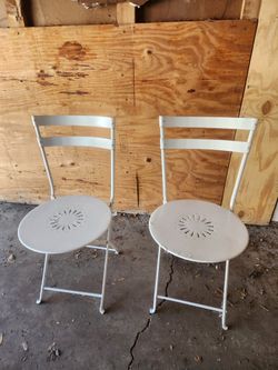 Two folding metal chairs in good condition