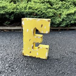 vintage rustic industrial aesthetic looking sign yellow letter E, 9” tall
