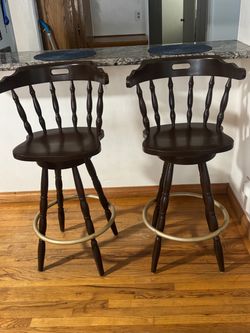 Pair of dark walnut wood swivel bar stools