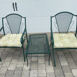Two green hire chairs patio with a paintball 75 for all three