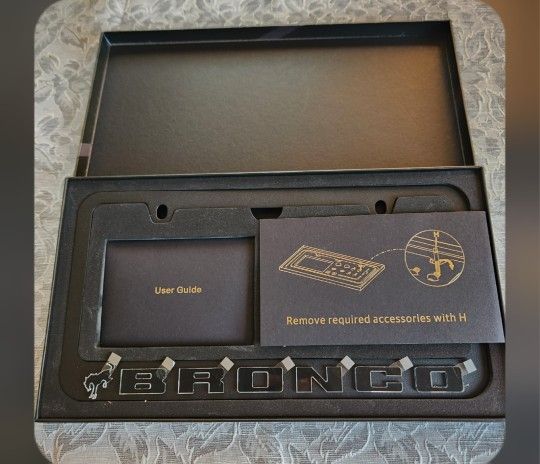 This premium license plate frame is crafted from matte black aluminum with bold raised lettering and a sleek, modern profile. It includes a full set o