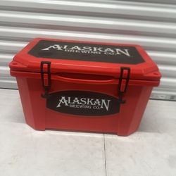 Grizzly Cooler 40Qt Alaskan  Brewing Company branded Bright Red Sweet. It’s used in good condition with some cosmetic blemishes. These blemishes are i