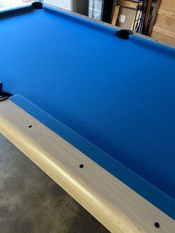 Pool table with balls and sticks and lite