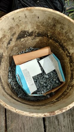 Bucket of galvanized inch and a quarter roofing nails