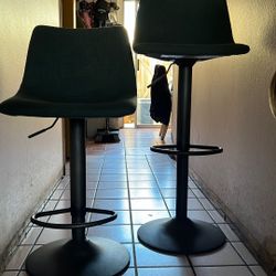 Two adjustable bar stools.