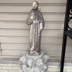 Garden statue of Saint Francis of Assisi. Patron Saint of animals & ecology. Surrounded by animals and sitting on top of a beautiful concrete base of 