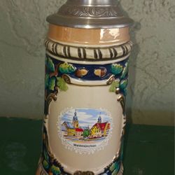 Vintqge German collectible beer stein with a metal lid.